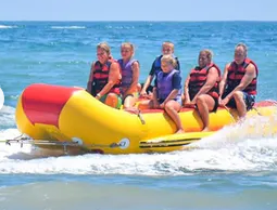 Family on a banana boat ride in the ocean