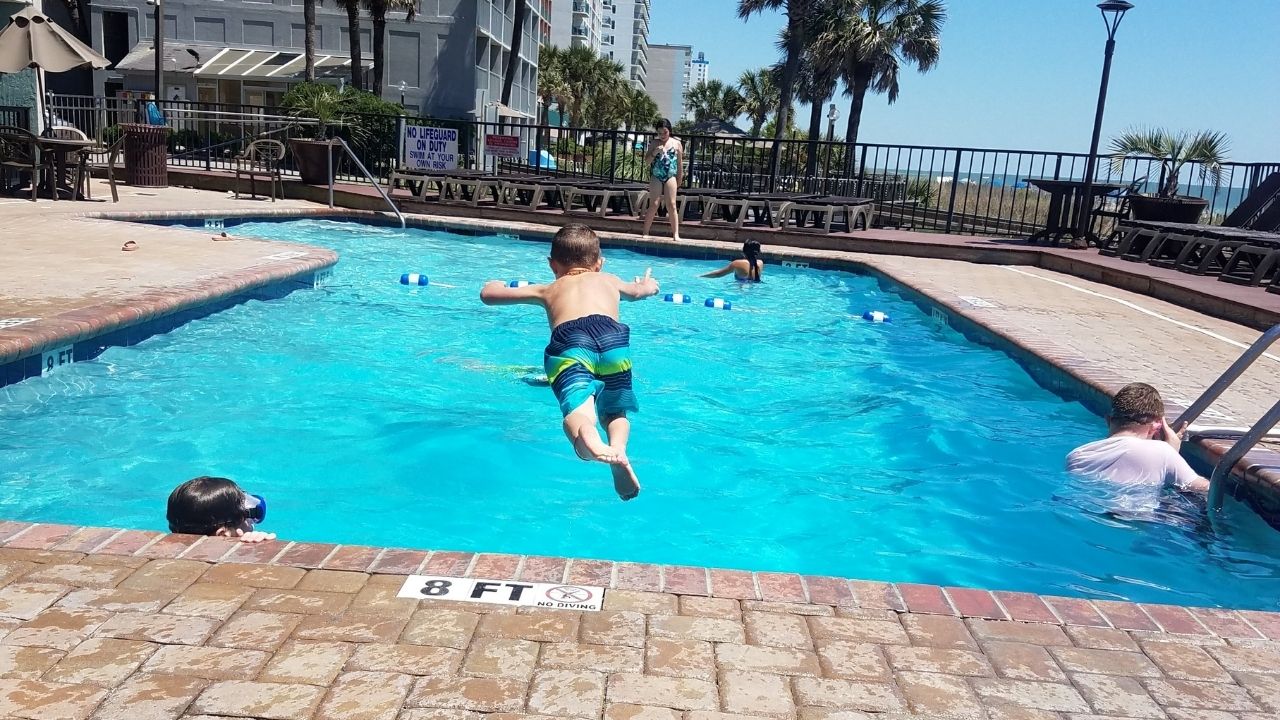 Boy Diving Into Pool