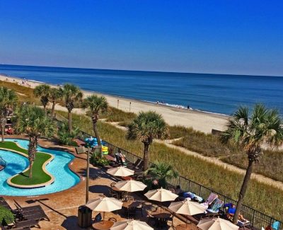 Drone of oceanfront pool deck at Compass Cove